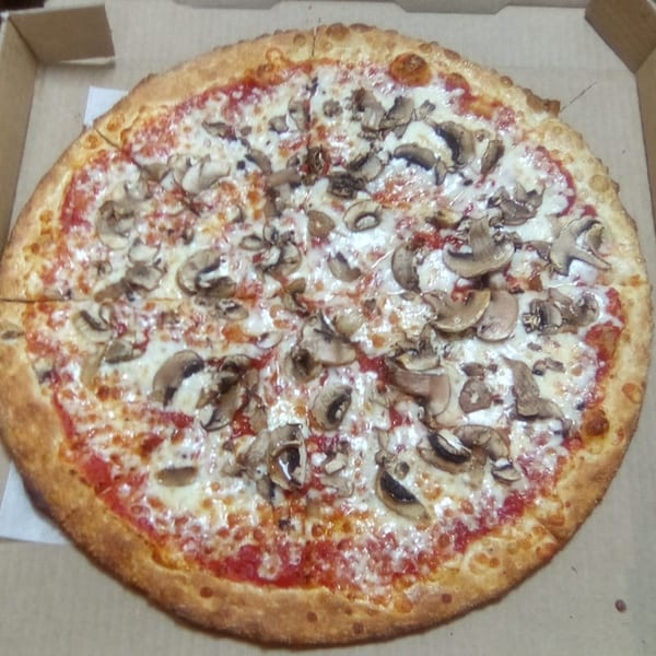 A whole mushroom pizza from Brooklyn Pizza, with melted cheese and red sauce, in a cardboard box.